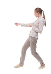 back view of standing girl pulling a rope from the top or cling