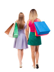  back view of  two women  with shopping bags