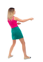 back view of standing girl pulling a rope from the top or cling