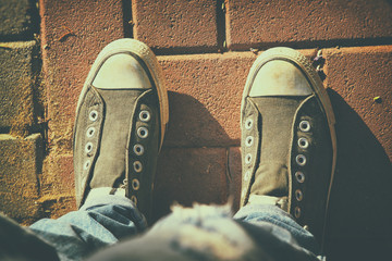 person with shoes over asphalt road
