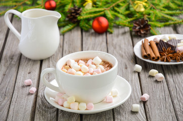 Hot chocolate with marshmallows on the rustic wooden table