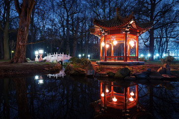 Traditional Chinese pavilions in Lazienki Park in Warsaw at nigh