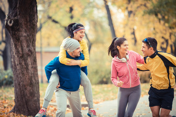 Young people jogging at the park.They relaxing and making fun.Autumn.