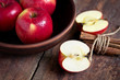 Red apples in a bowl with cinnamon 