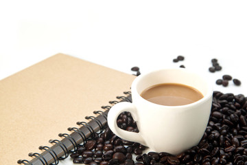 Cup of coffee and book on white background