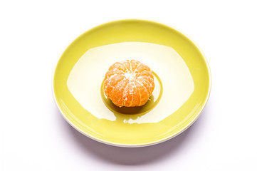 one shelled mandarin on saucer