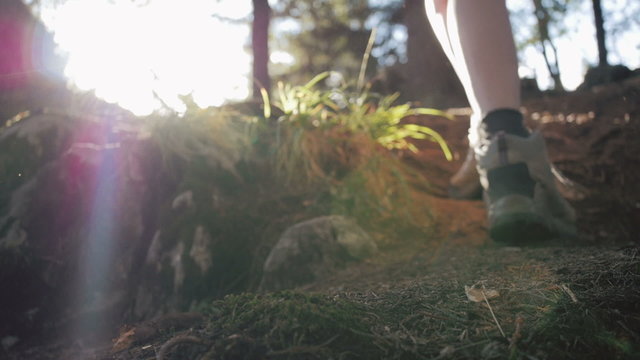 Close up of women legs hiking steep terrain in slow motion