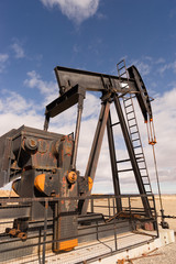 Fototapeta na wymiar Wyoming Industrial Oil Pump Jack Fracking Crude Extraction Machi