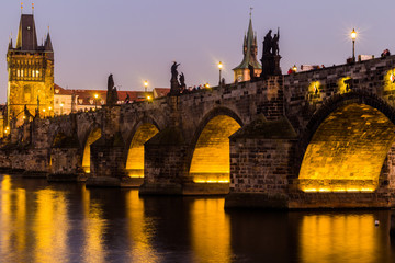 Fototapeta na wymiar View at The Charles Bridge and Vltava river in Prague in dusk at sunset, Czech Republic