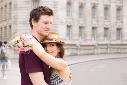 young couple hugging in the street