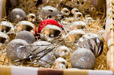 Box with silver christmas bulbs, one is red