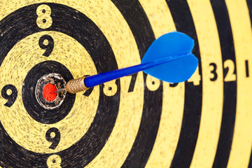Lucky concept: photography success hitting target aim goal Blue Dart in bull's eye