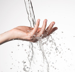 Closeup woman hand under the stream of water