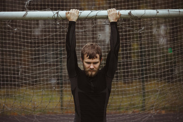 Male athlete resting on soccer field