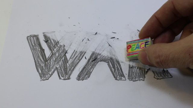 rubber eraser with written PEACE deletes the written WAR