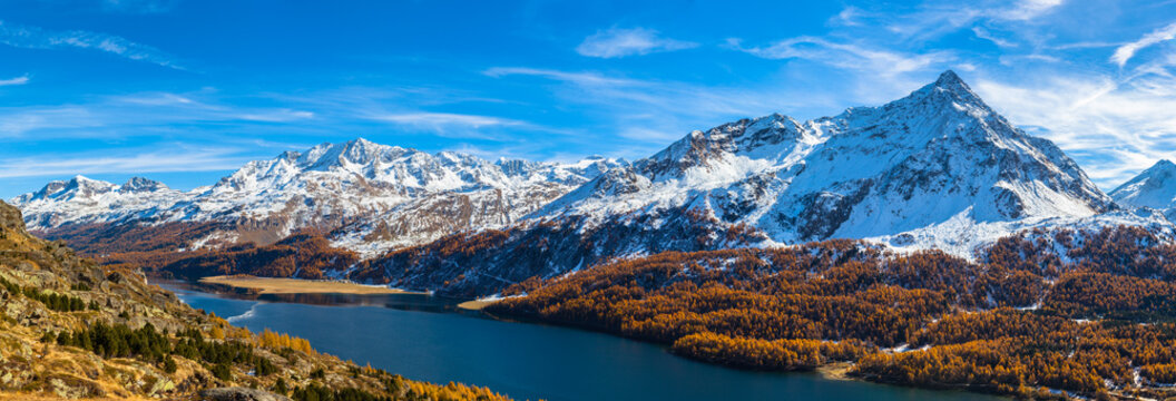 Panorama view of Sils lake and the Engadin Alps in golden autumn