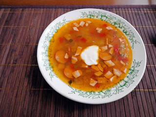 Meat soup in the bowl on the table