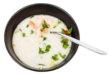 above view of sour and spicy soup Tom yam in bowl