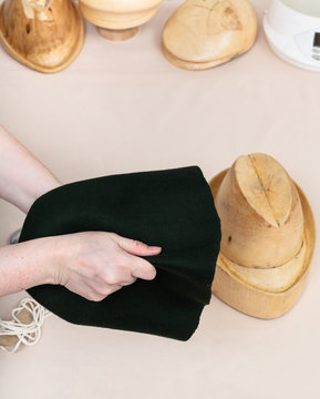hatter preparing a felt hood for shaping