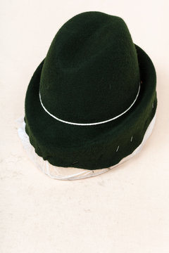 felt hood fixed on wooden hat-block for shaping