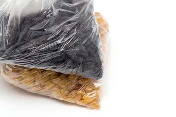 black and yellow raisins in a plastic bag