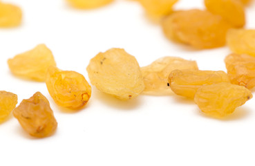 Golden raisins on a white background