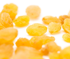 Golden raisins on a white background