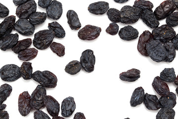 Black raisins on a white background. macro