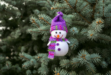 merry snowman on the background of Christmas tree