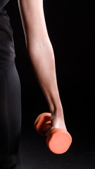 Woman Holding Dumbbell on Black Background
