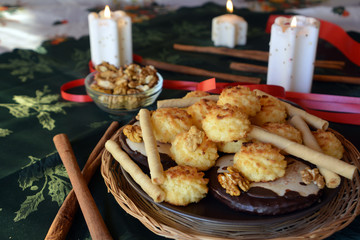 Lovely close up image of Christmas cookies on a decorated table with lighted candles