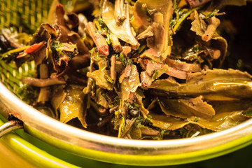 Close up tee strainer with herbal leaves