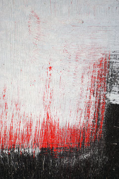 Brushstroke with white,black and red paint  on dusty metal