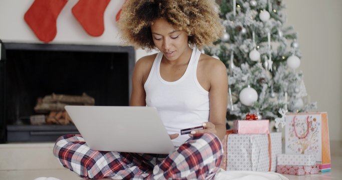 Young woman shopping online for Christmas