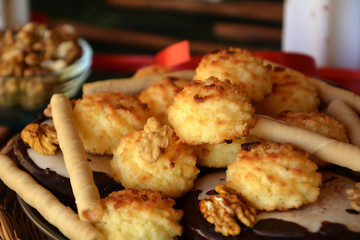 Lovely close up image of Christmas coconut cookies on a decorated table 