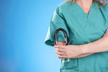 Doctor with a stethoscope on blue background