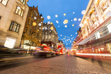 Oxford street in London with Christmas lights and blurred traffi