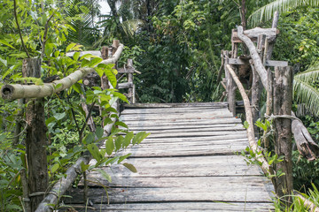 old wooden bridge across the Creek in the woods
