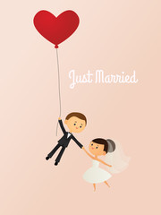 Just married bride and groom with a heart shaped balloon
