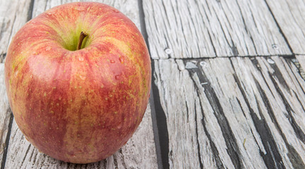 Fresh Japanese Fuji apple over wooden background