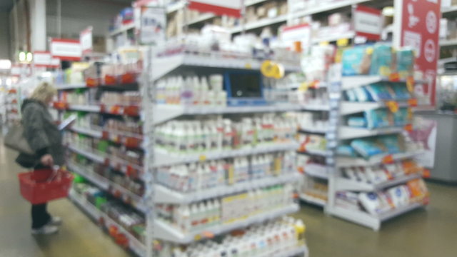 People in the interior of a building materials and household goods supermarket, defocused