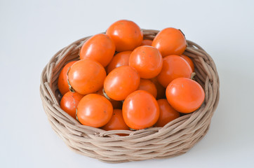 kaki persimmon in wooden basket