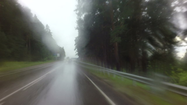 Travel by car in heavy rain on Altai Krai.