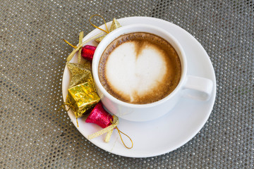 Close up blue cup of Coffee, latte on the steel table with Christmas decorations