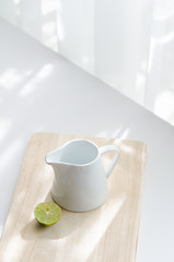 Still life with lemon and white jug