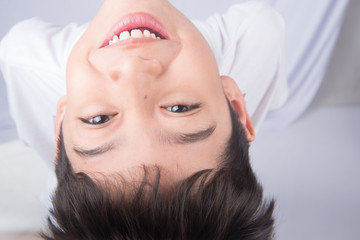 Little boy looking up with smiling on white background