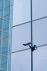Outdoor surveillance camera on the wall of modern building