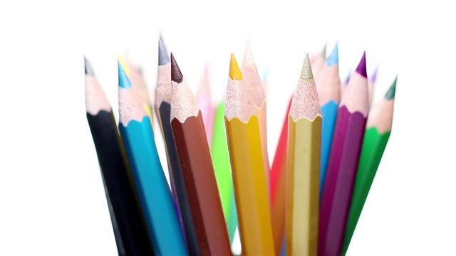 Top of color pencils turning on a white background
