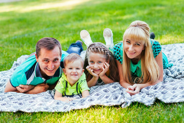 Fototapeta premium Family lying down in the park