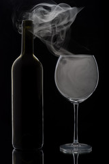 Smoking wine glass and bottle